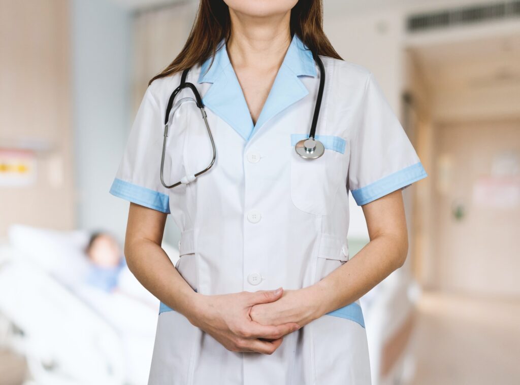 woman in a nurse coat with a stethoscope around her neck