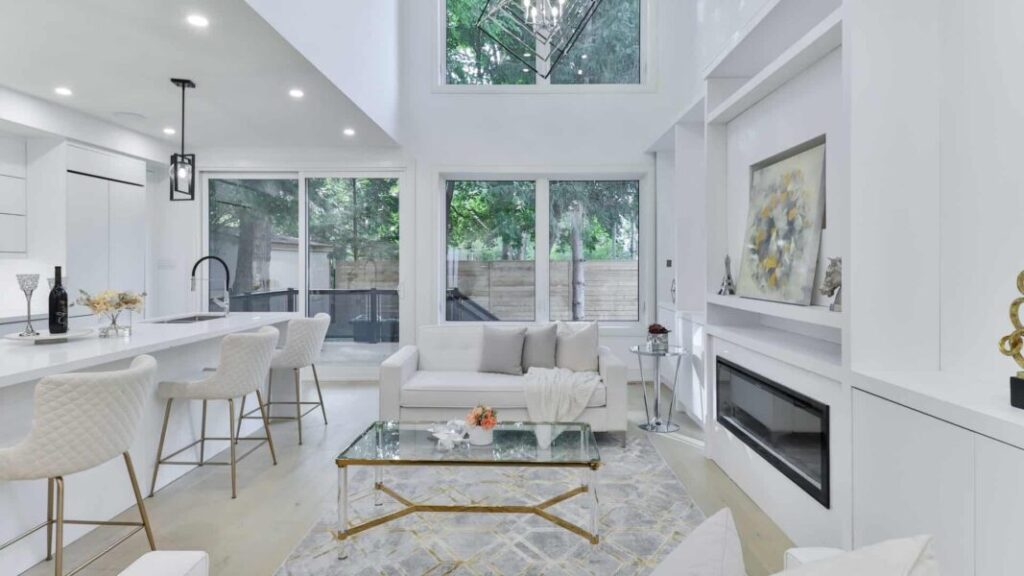 white room with white furniture and glass table